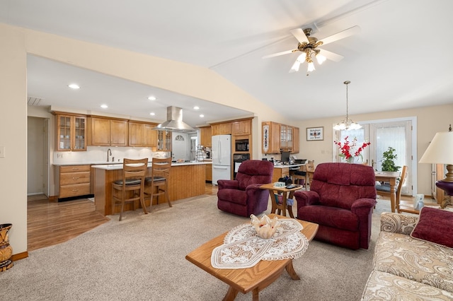 living area featuring a ceiling fan, recessed lighting, wet bar, light colored carpet, and vaulted ceiling