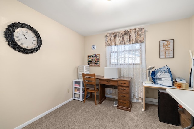 home office with baseboards and light colored carpet