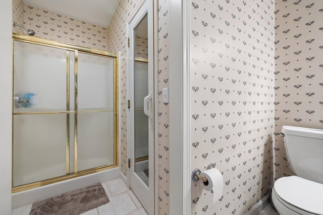 bathroom with a shower stall, wallpapered walls, toilet, and tile patterned flooring
