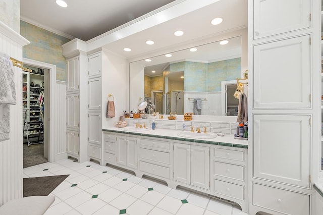 full bath with vanity, crown molding, recessed lighting, a spacious closet, and a shower stall