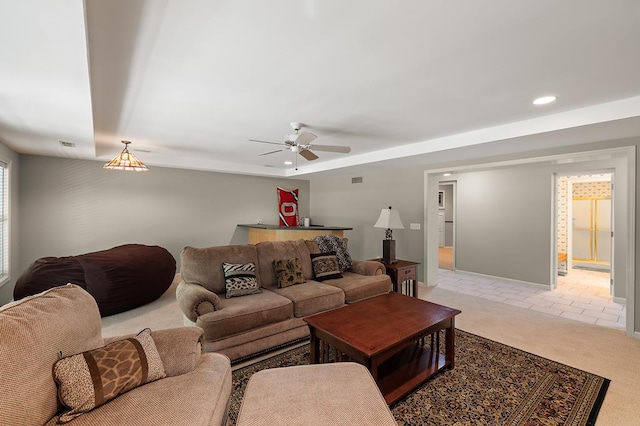 living room with baseboards, recessed lighting, a ceiling fan, and light colored carpet