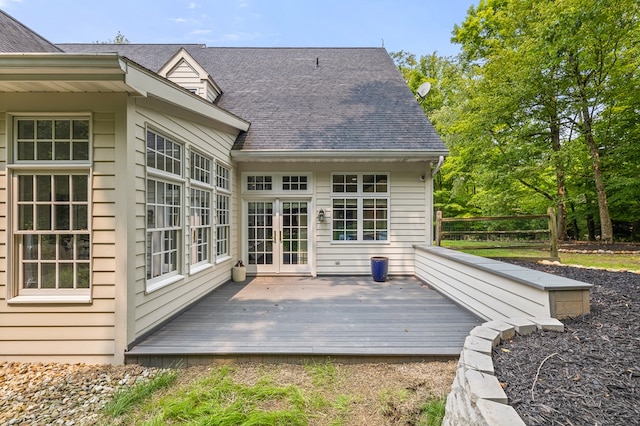 rear view of house with french doors, roof with shingles, and a wooden deck
