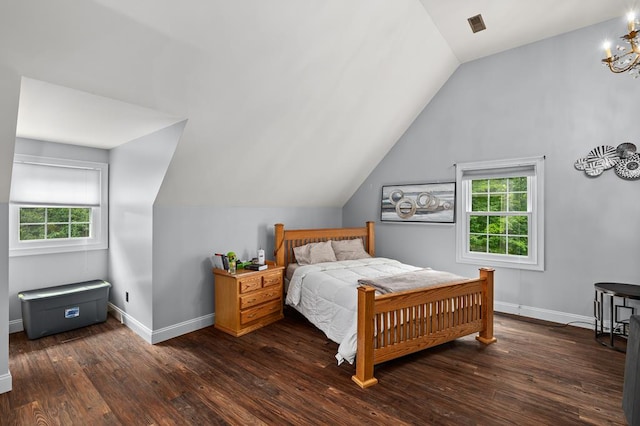bedroom with multiple windows, baseboards, and hardwood / wood-style flooring