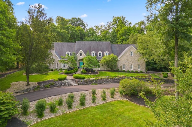 view of front of home with stone siding and a front yard