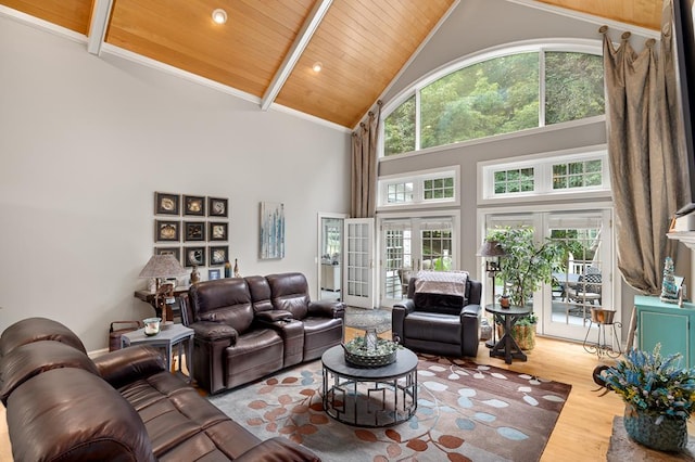 living area featuring beamed ceiling, high vaulted ceiling, wood finished floors, and wood ceiling
