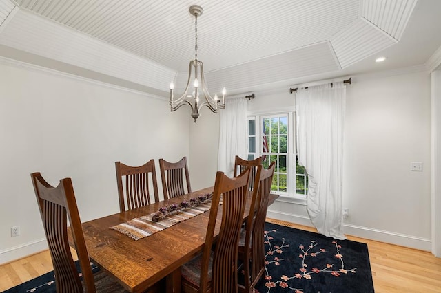 dining room with baseboards, wood finished floors, an inviting chandelier, and recessed lighting