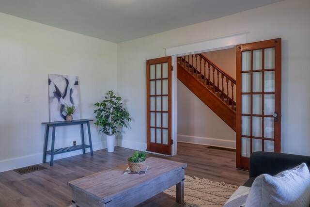 1676 Old Delaware Rd, Mount Vernon, OH 43050 - living room with french doors, stairway, and wood finished floors