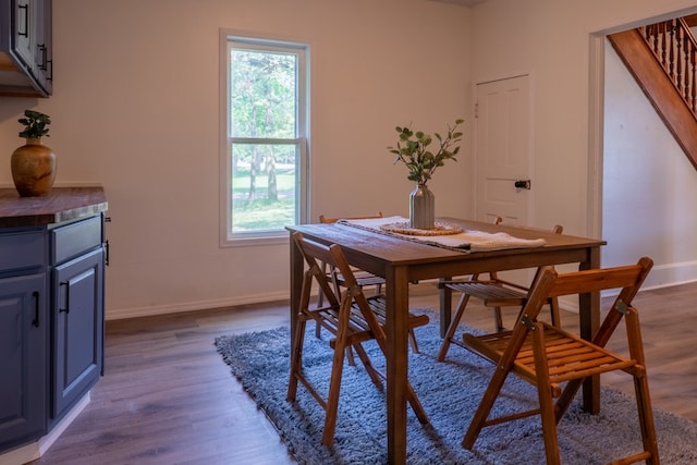1676 Old Delaware Rd, Mount Vernon, OH 43050 - dining area featuring healthy amount of natural light, dark wood-style flooring, and stairs