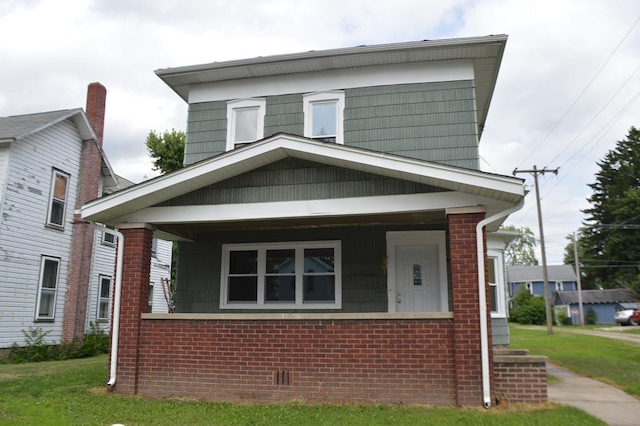 view of front of home with a front lawn and covered porch