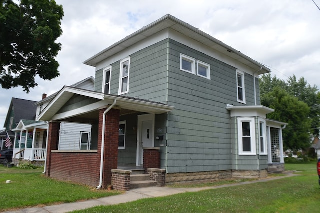 view of front facade with covered porch and a front yard