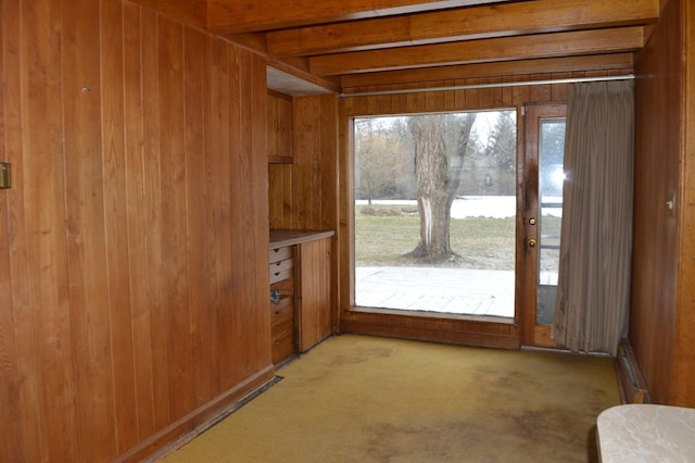 entryway featuring beam ceiling, baseboard heating, and wood walls