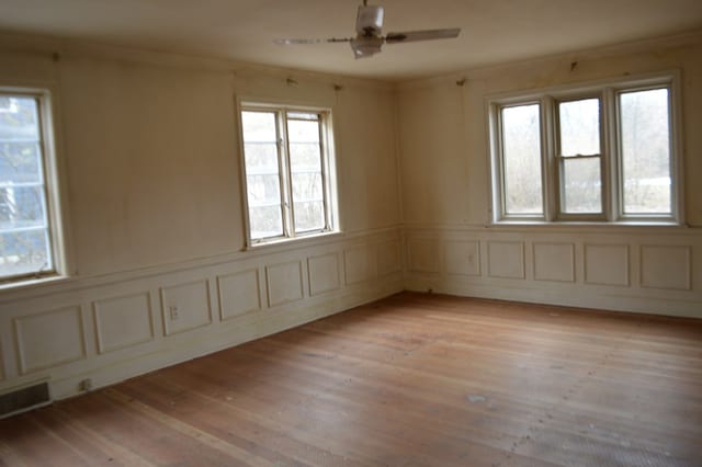 spare room featuring ceiling fan and light hardwood / wood-style flooring