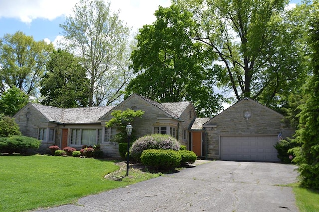 view of front of home with a front yard and a garage