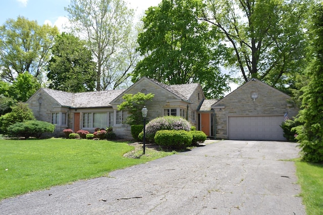 view of front of house with a front yard and a garage