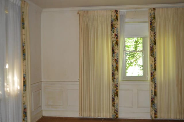 empty room featuring crown molding