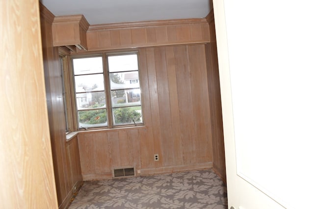 unfurnished room with wooden walls