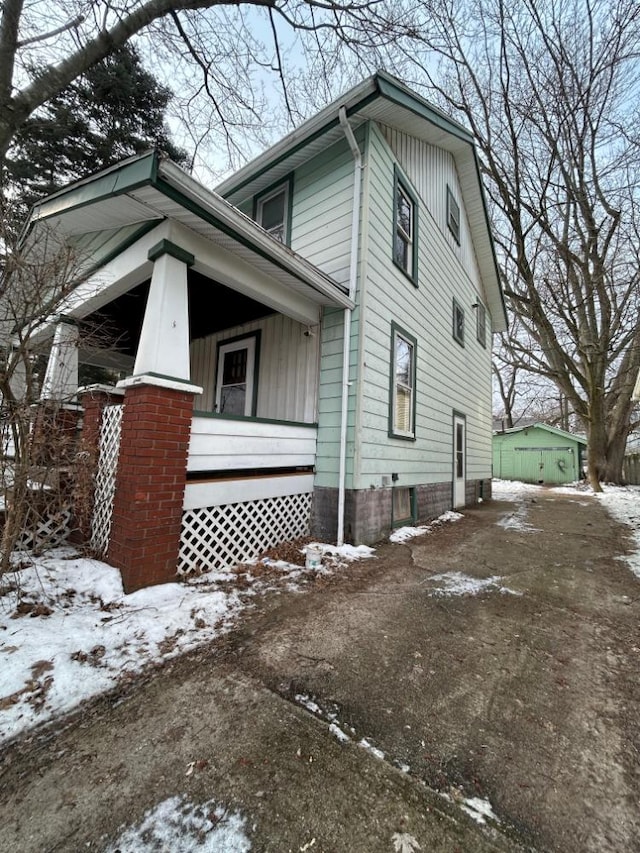 view of snow covered exterior featuring a porch