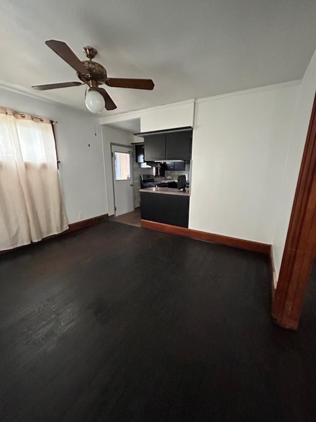 unfurnished living room with dark hardwood / wood-style floors and ceiling fan