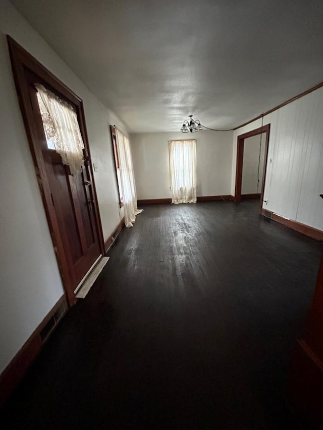 unfurnished room with dark wood-type flooring