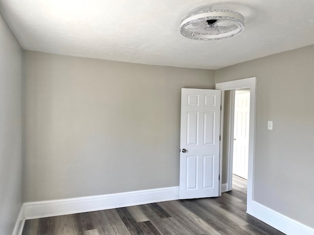 empty room with dark wood-type flooring