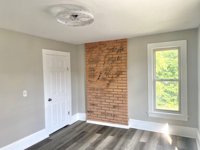 spare room featuring dark wood-type flooring