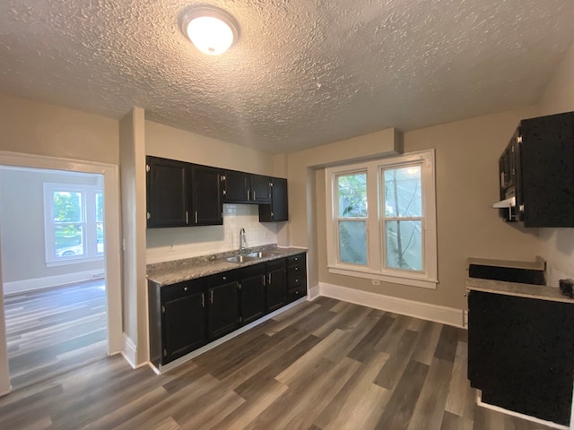 kitchen featuring a textured ceiling, dark hardwood / wood-style flooring, and sink