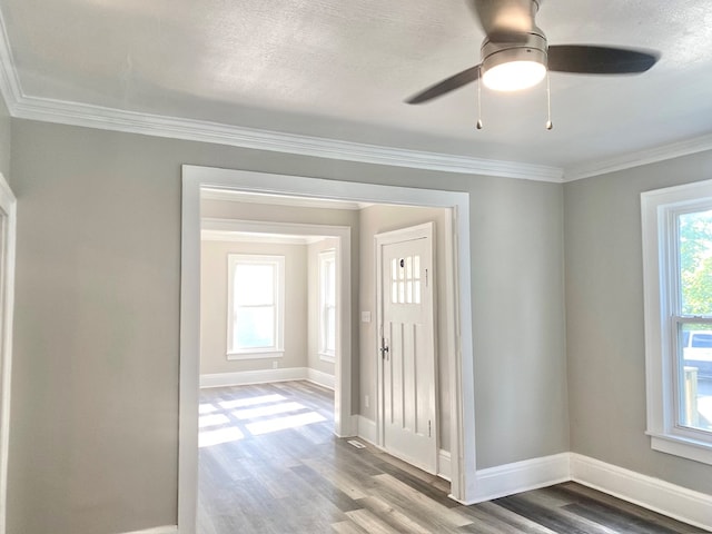 foyer featuring wood-type flooring, a textured ceiling, ceiling fan, and ornamental molding