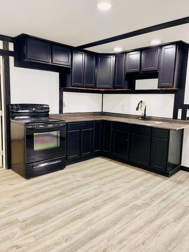 328 Newman St, Mansfield, OH 44902 - kitchen with a sink, black / electric stove, light wood finished floors, dark cabinets, and recessed lighting