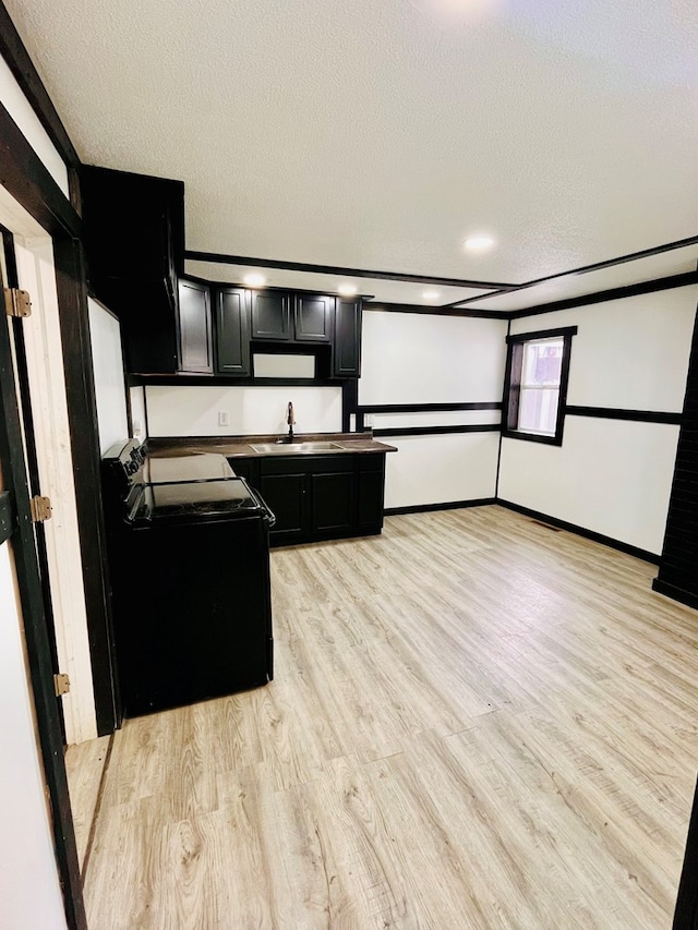 328 Newman St, Mansfield, OH 44902 - kitchen with a sink, light wood-style flooring, baseboards, dark cabinets, and black range with electric stovetop