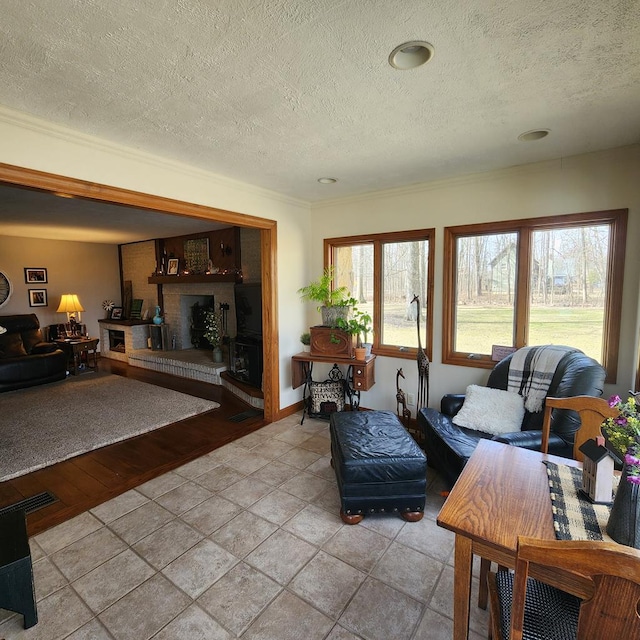 living area featuring a textured ceiling and a brick fireplace