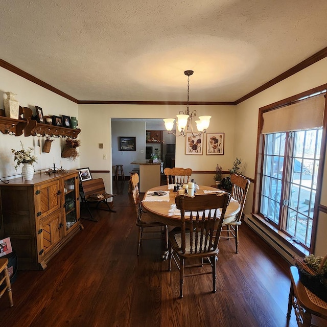 dining room with dark wood-style floors, ornamental molding, a textured ceiling, and a chandelier