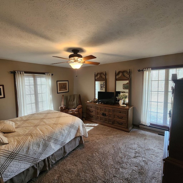 carpeted bedroom featuring a textured ceiling and a ceiling fan