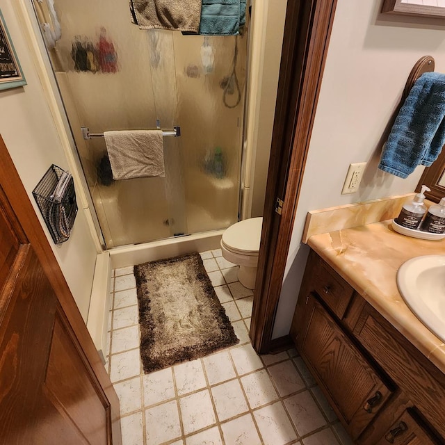 bathroom featuring a stall shower, vanity, and toilet