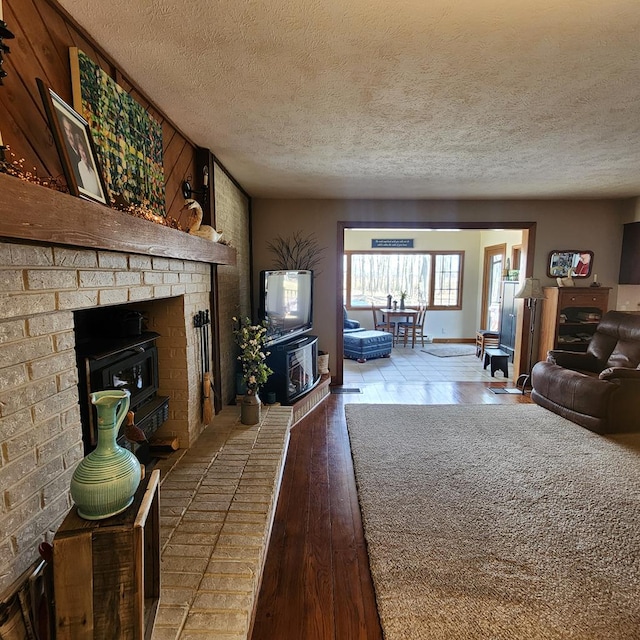 living area featuring a textured ceiling and hardwood / wood-style floors