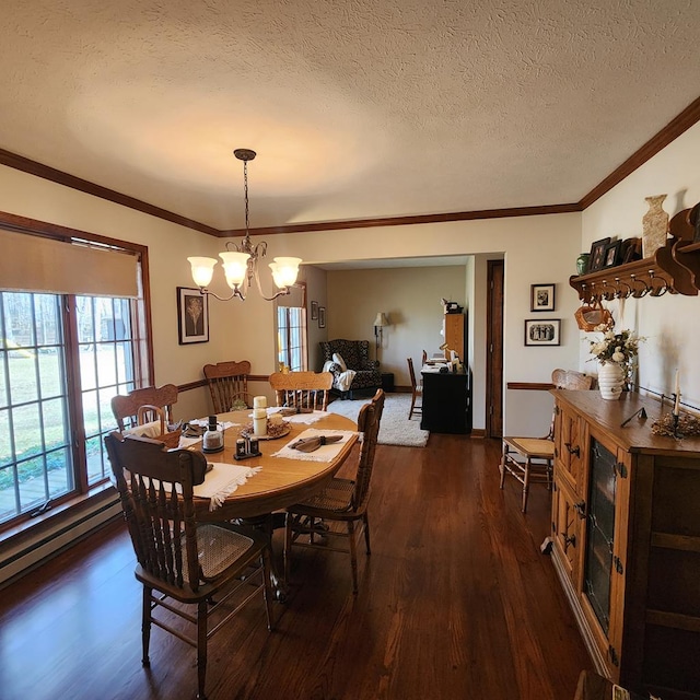 dining space with dark wood-type flooring, ornamental molding, a textured ceiling, and an inviting chandelier