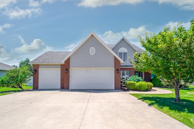 2453 Whitney Ave, Ontario, OH 44906 - view of front of property featuring an attached garage, brick siding, driveway, and a front lawn