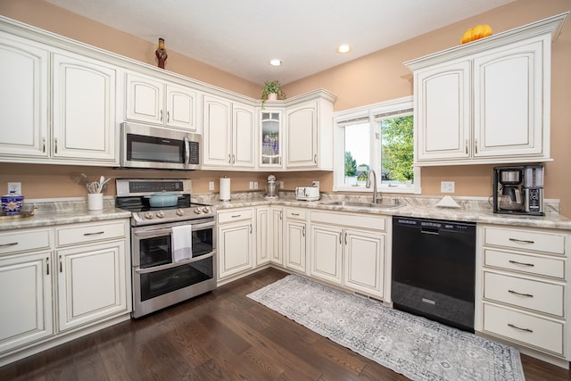 2453 Whitney Ave, Ontario, OH 44906 - kitchen with appliances with stainless steel finishes, dark wood-style flooring, light countertops, and recessed lighting
