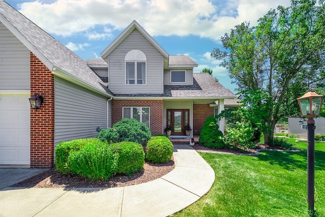 2453 Whitney Ave, Ontario, OH 44906 - traditional-style house featuring brick siding, a front lawn, a shingled roof, and an attached garage