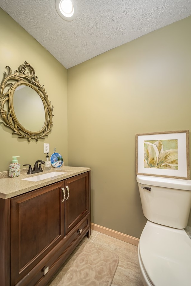 2453 Whitney Ave, Ontario, OH 44906 - half bath featuring vanity, a textured ceiling, and tile patterned floors