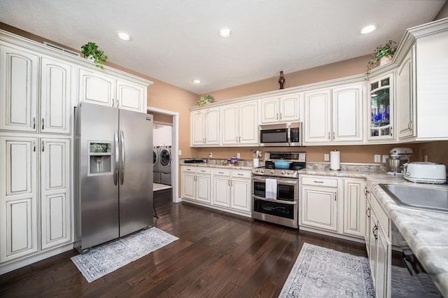 2453 Whitney Ave, Ontario, OH 44906 - kitchen with appliances with stainless steel finishes, washer and dryer, dark wood finished floors, glass insert cabinets, and recessed lighting