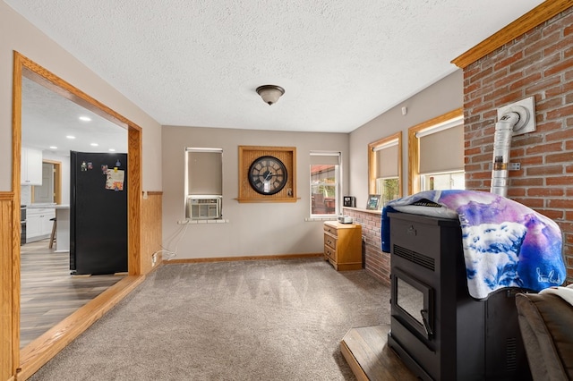 interior space featuring carpet flooring, cooling unit, and a textured ceiling