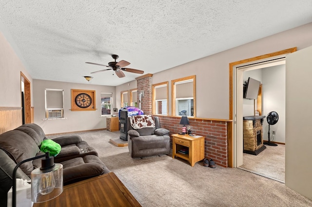 living room featuring a textured ceiling, light colored carpet, ceiling fan, and cooling unit