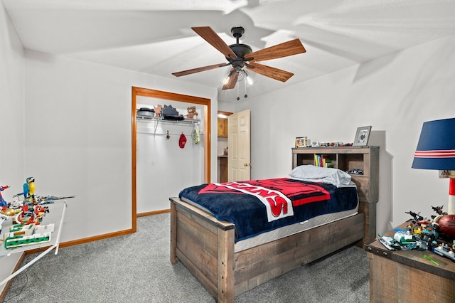 carpeted bedroom featuring ceiling fan and a closet