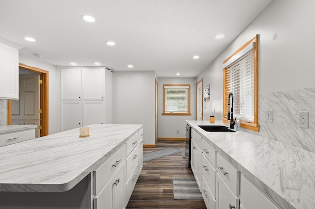 kitchen with dark hardwood / wood-style flooring, sink, white cabinetry, a center island, and wine cooler