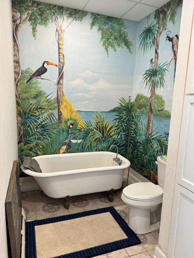 796 US Highway 224, Willard, OH 44890 - bathroom featuring tile patterned floors, a freestanding bath, and toilet