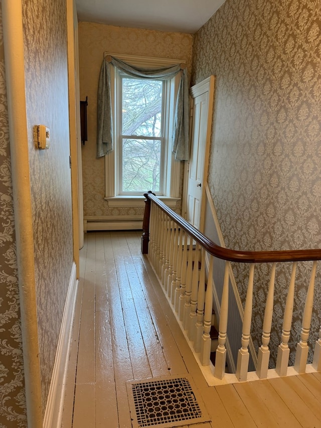796 US Highway 224, Willard, OH 44890 - stairway featuring wallpapered walls, baseboard heating, and wood-type flooring