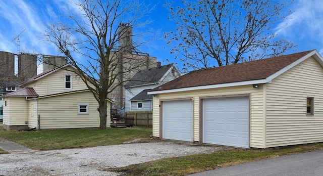 detached garage featuring fence