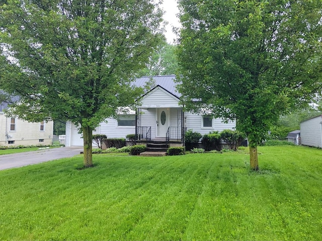 321 Lee Ln, Mansfield, OH 44905 - obstructed view of property with asphalt driveway, a front yard, and a garage