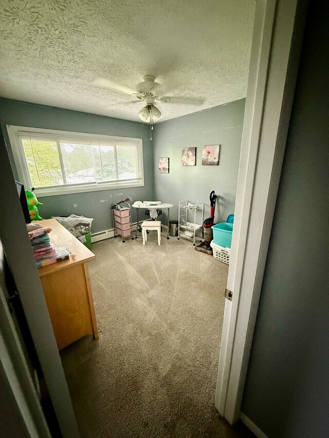 950 Woodbine St, Willard, OH 44890 - home office with a textured ceiling, carpet floors, baseboards, a ceiling fan, and a baseboard heating unit