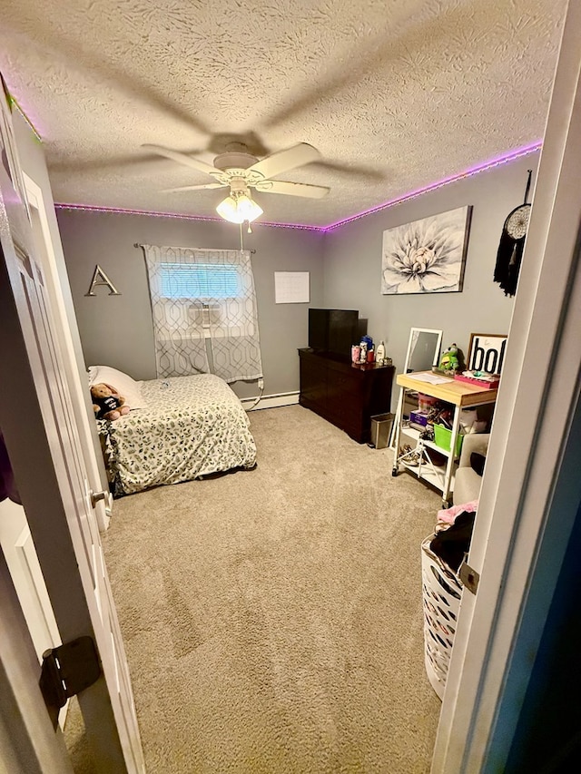 950 Woodbine St, Willard, OH 44890 - carpeted bedroom featuring a baseboard radiator, a textured ceiling, and a ceiling fan